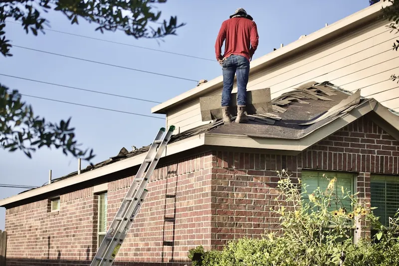 Professional roofer working on a residential roof in Pine Bay